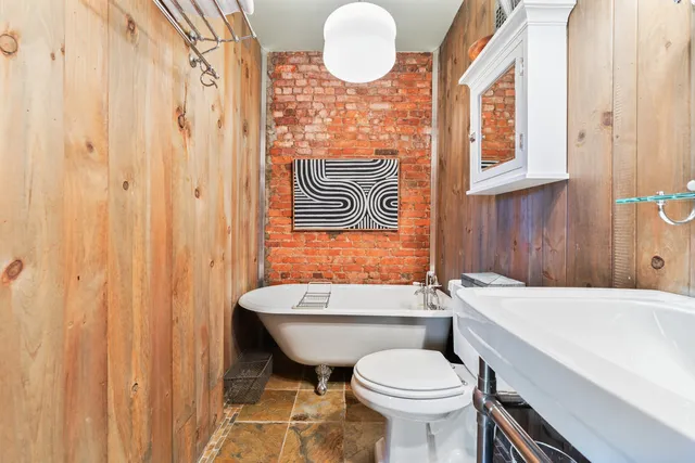 a bathroom with a sink a toilet and bathtub