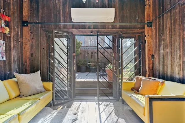 a backyard of a house with sofas