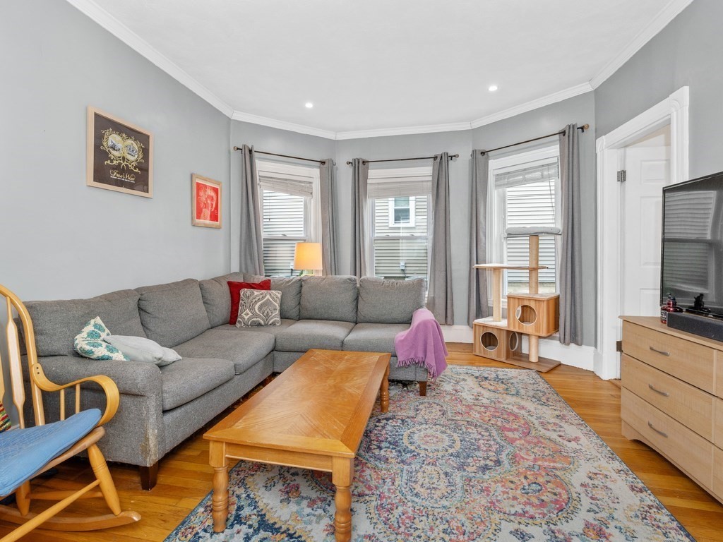 10 Edith Avenue, Unit 1 Everett, MA 02149 - Photo 2 of 12 a living room with furniture and a flat screen tv