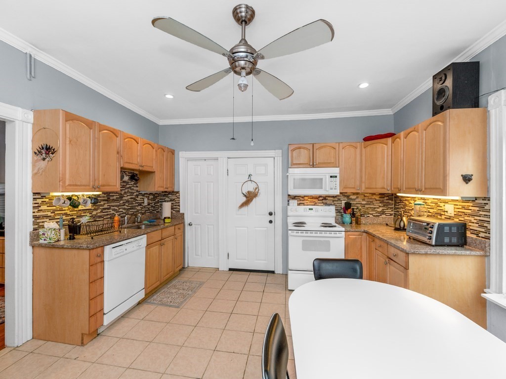 10 Edith Avenue, Unit 1 Everett, MA 02149 - Photo 4 of 12 a kitchen with stainless steel appliances a stove a sink and white cabinets