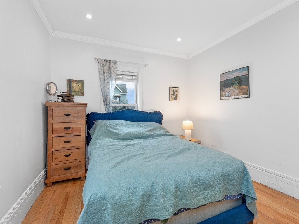 10 Edith Avenue, Unit 1 Everett, MA 02149 - Photo 7 of 12 a bedroom with a bed and a dresser