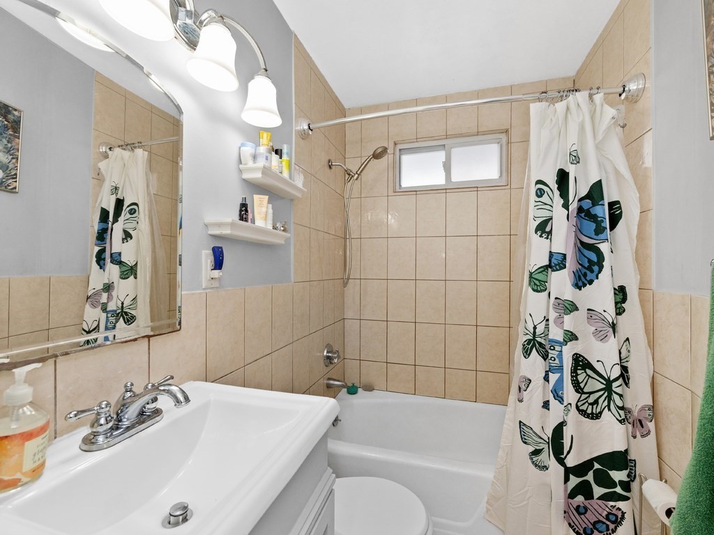 10 Edith Avenue, Unit 1 Everett, MA 02149 - Photo 9 of 12 a bathroom with a sink a toilet and shower