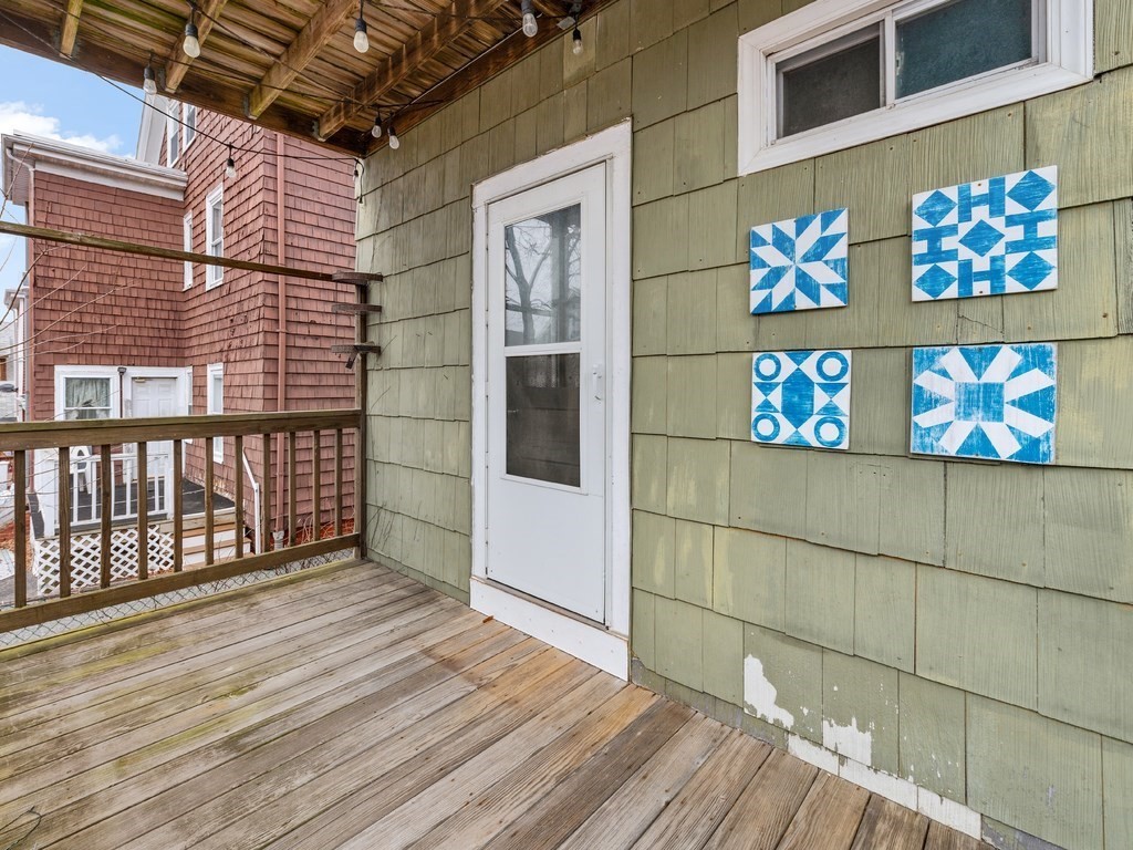 10 Edith Avenue, Unit 1 Everett, MA 02149 - Photo 10 of 12 a view of an empty room with wooden floor and a window