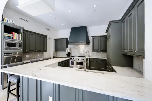 a kitchen with stainless steel appliances a sink stove and refrigerator