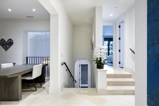 a hall way with a furniture and mirror