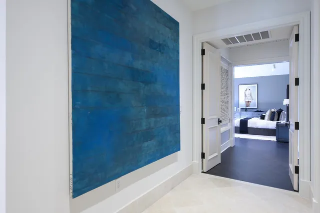 a bedroom with bed and large windows