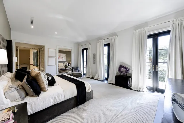 a bathroom with a double vanity sink mirror and bathtub