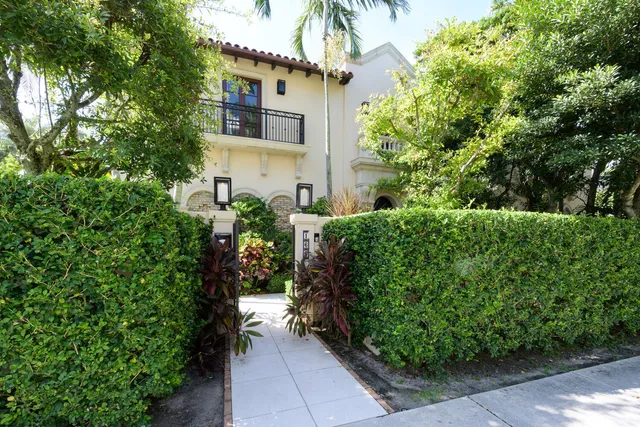 a view of a house with potted plants