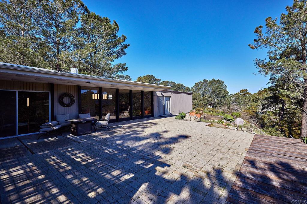 1234 Oribia Road Del Mar, CA 92014 - Photo 13 of 22 a view of a house with backyard sitting area and covered with trees