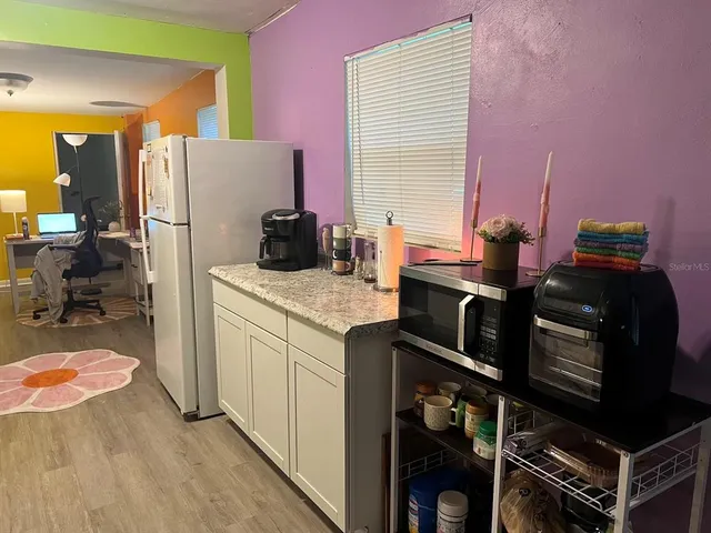 a kitchen with a sink a counter space and a window