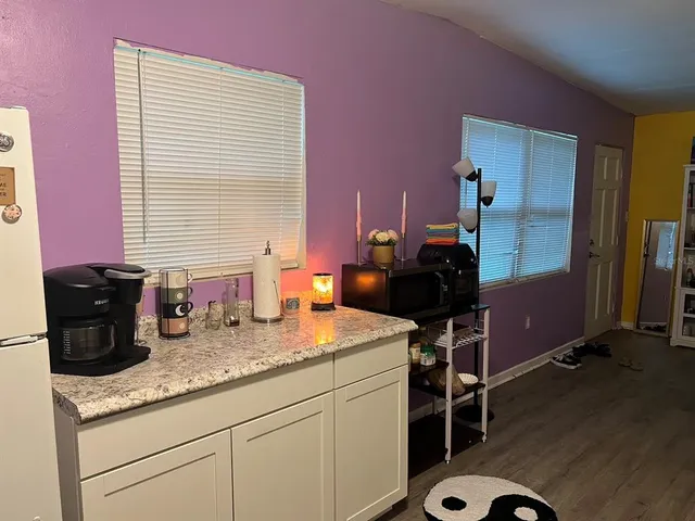 a kitchen with a refrigerator and a stove