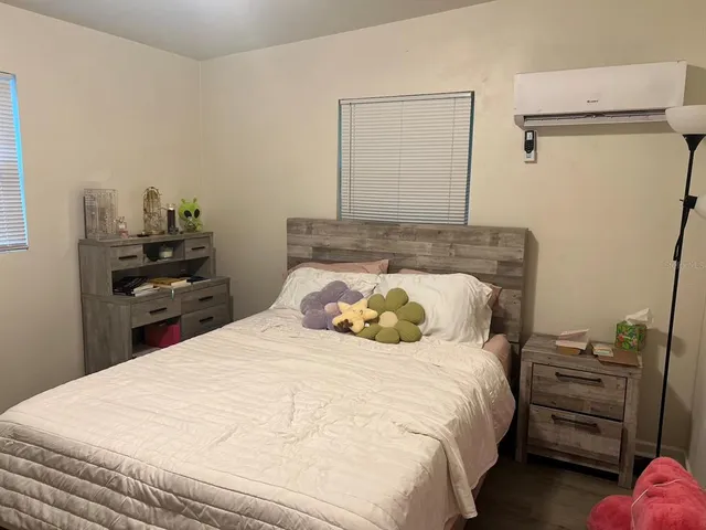 a bedroom with a bed and a desk