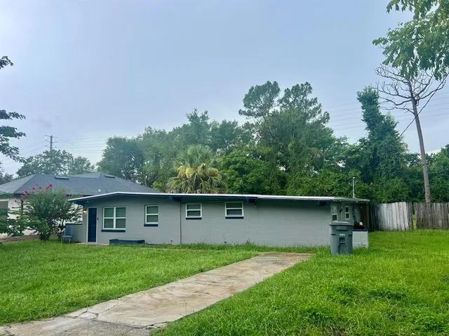 a front view of a house with a yard and a garage