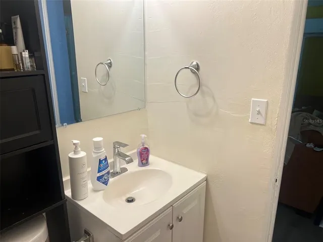 a bathroom with a shower curtain and a sink