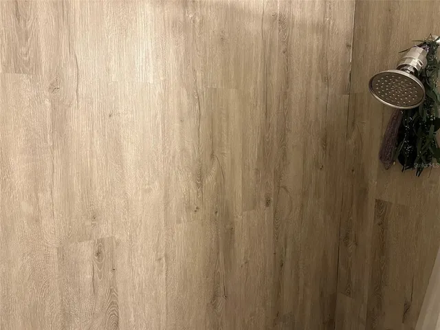 a bathroom with a shower toilet and sink