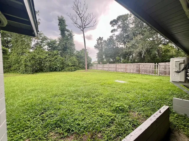 a view of a field with an trees in the background