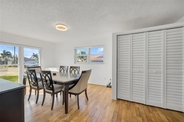 a dining room with furniture and wooden floor