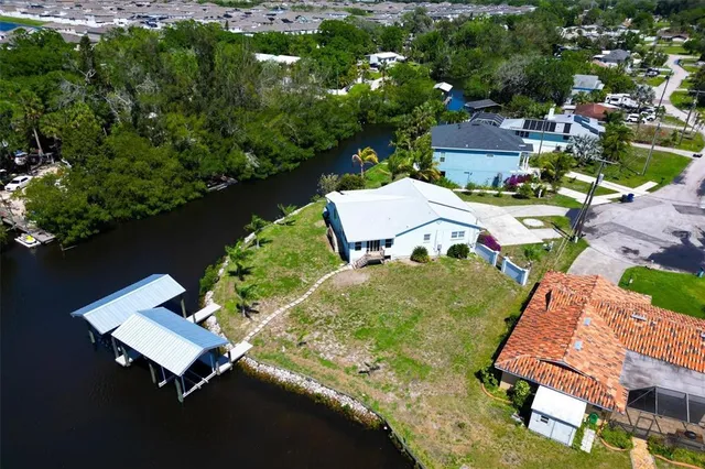 an aerial view of a house with garden space and street view
