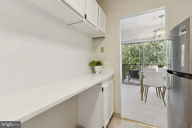 a hallway with cabinets and a stove
