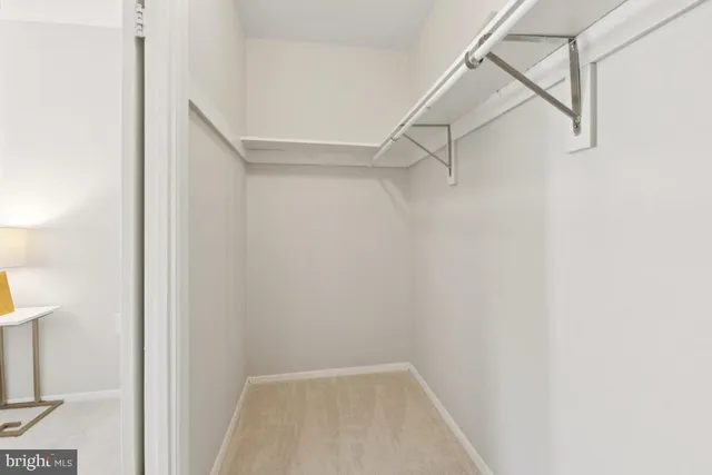 a bedroom with a bed and painting on the wall