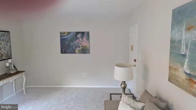 a view of a chair and potted plant in a room