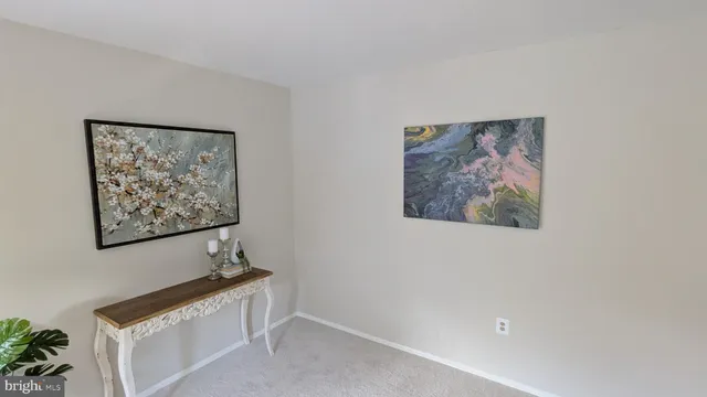 a view of a hallway with paintings on the wall