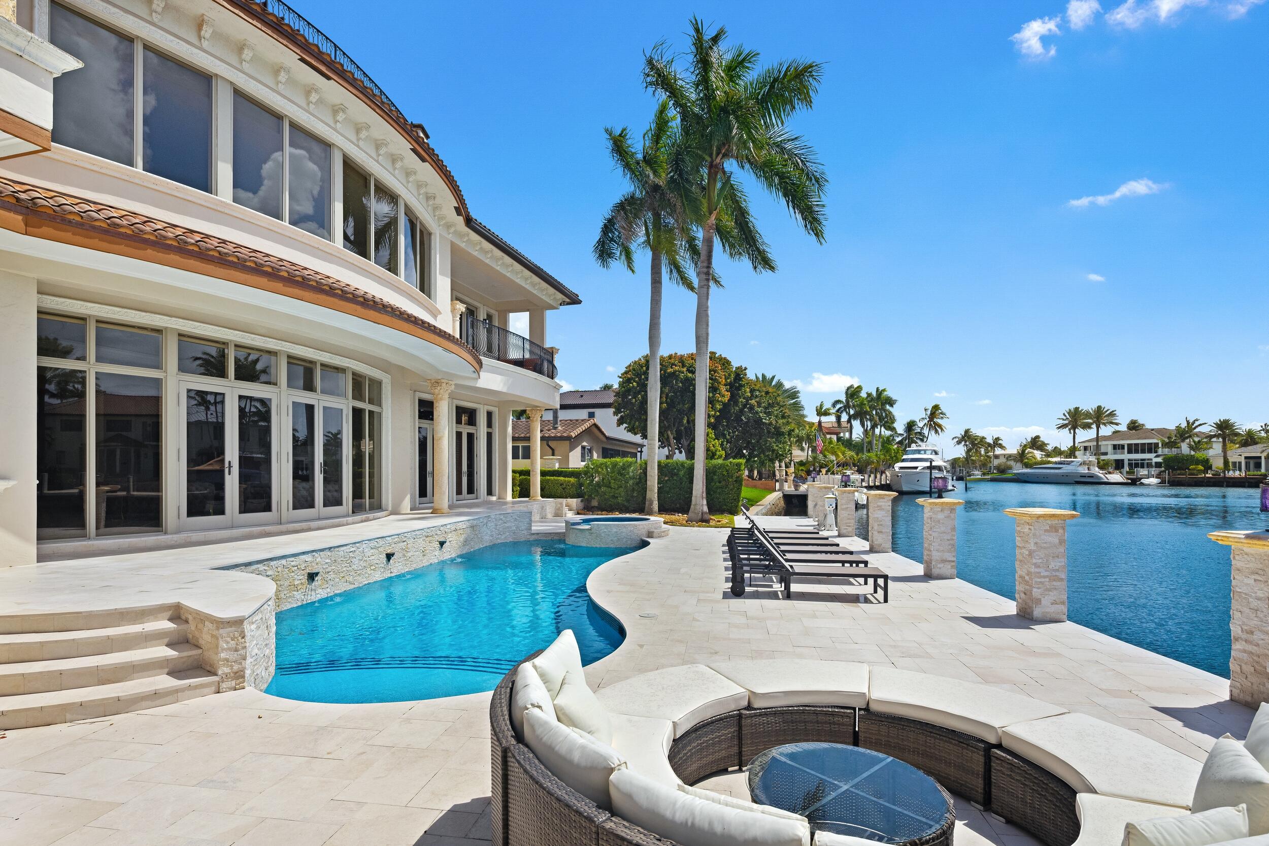 3201 Northeast 27th Avenue Lighthouse Point, FL 33064 - Photo 24 of 66 a view of a patio with couches table and chairs and potted plants