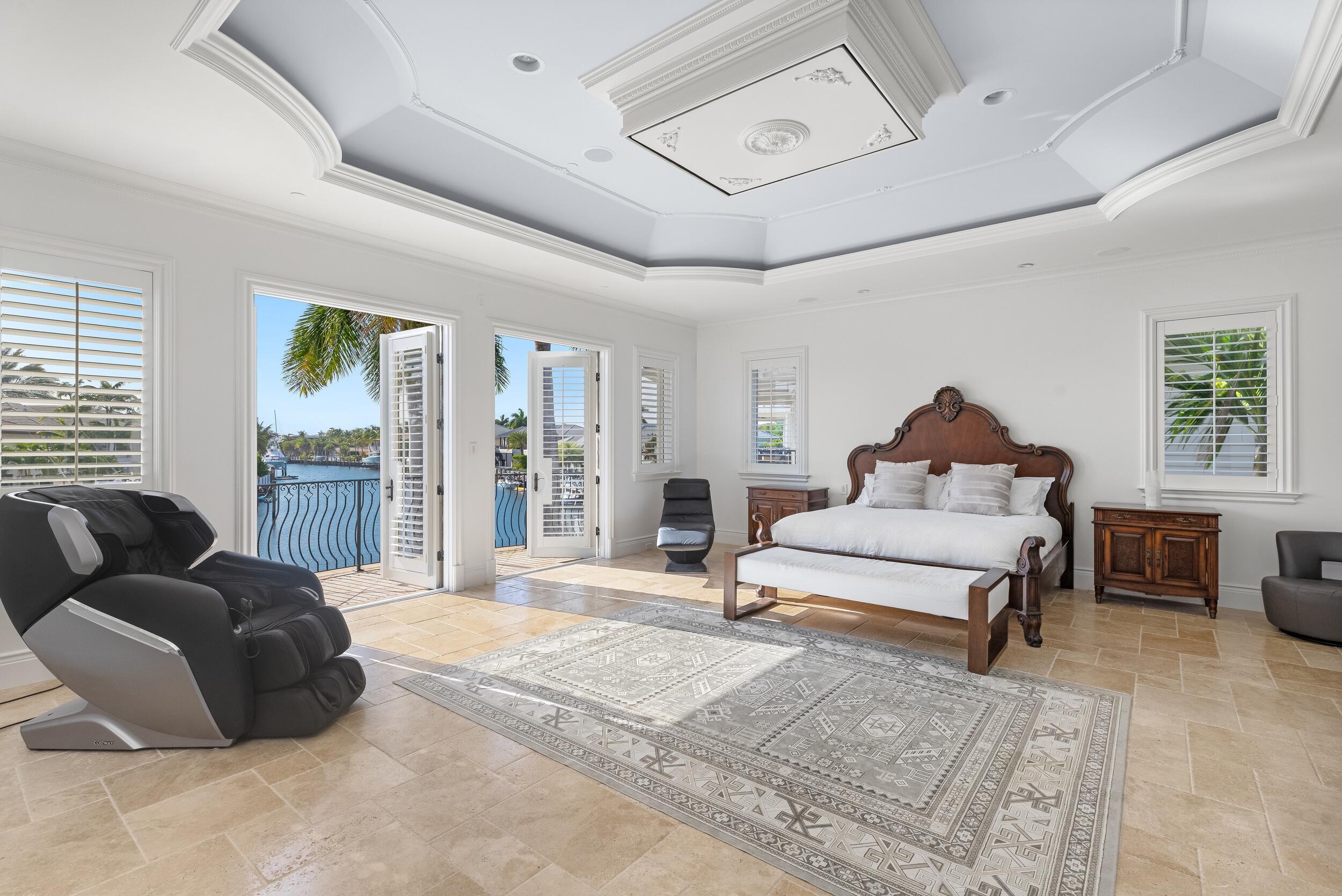 3201 Northeast 27th Avenue Lighthouse Point, FL 33064 - Photo 31 of 66 a spacious bedroom with a bed a couch and a window