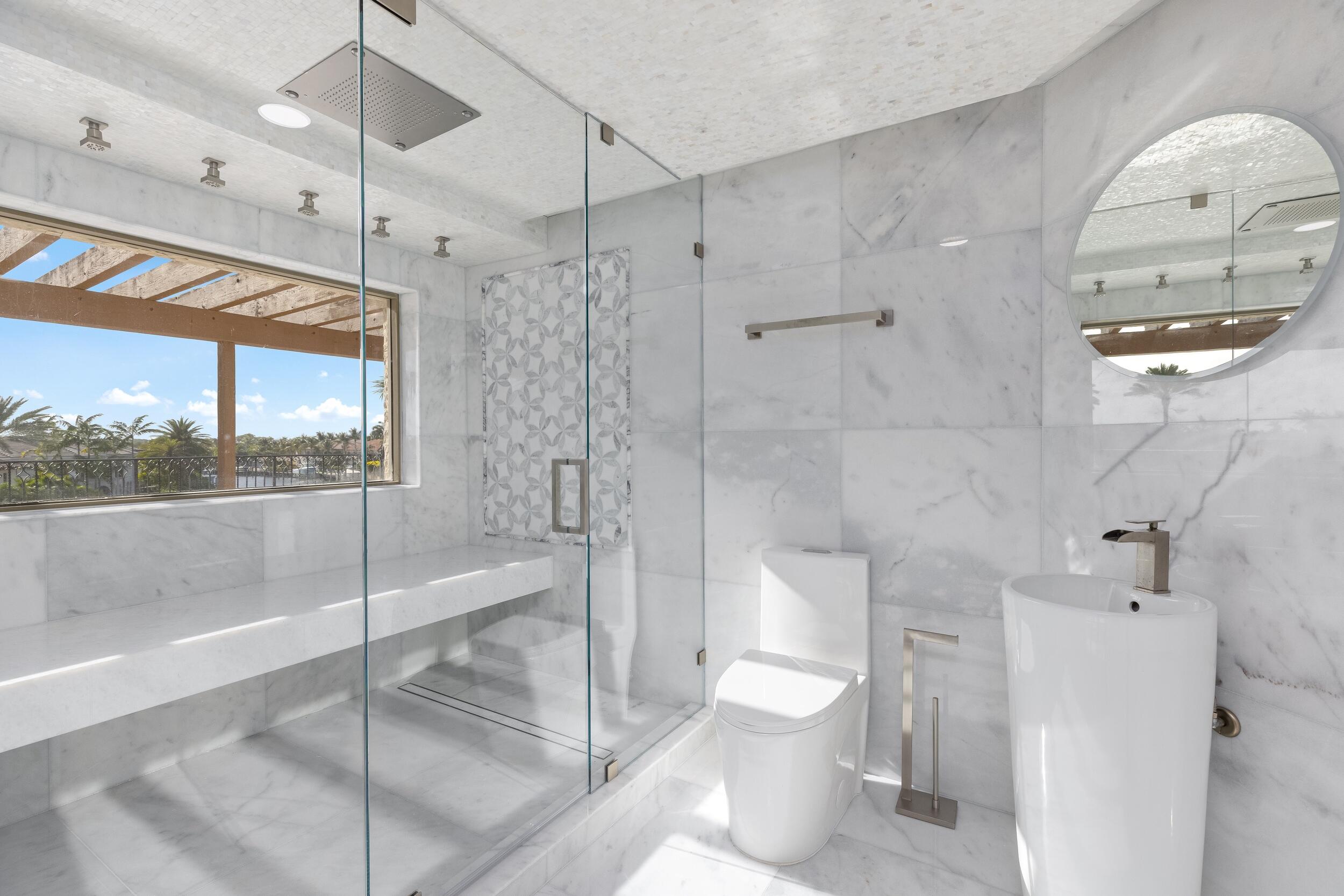 3201 Northeast 27th Avenue Lighthouse Point, FL 33064 - Photo 45 of 66 a bathroom with a toilet a sink and shower