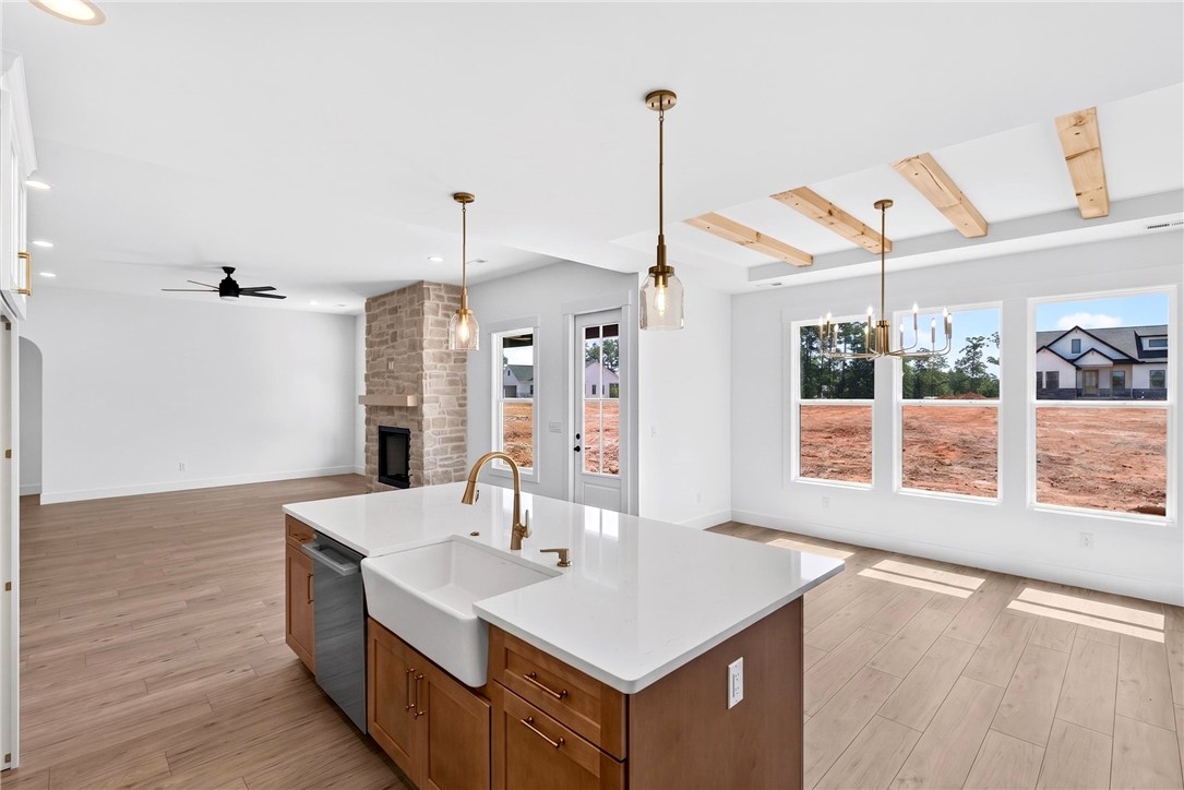 416 Blume Road Anderson, SC 29625 - Photo 10 of 29 A well-lit, open-concept interior features a spacious kitchen island and a stone fireplace.