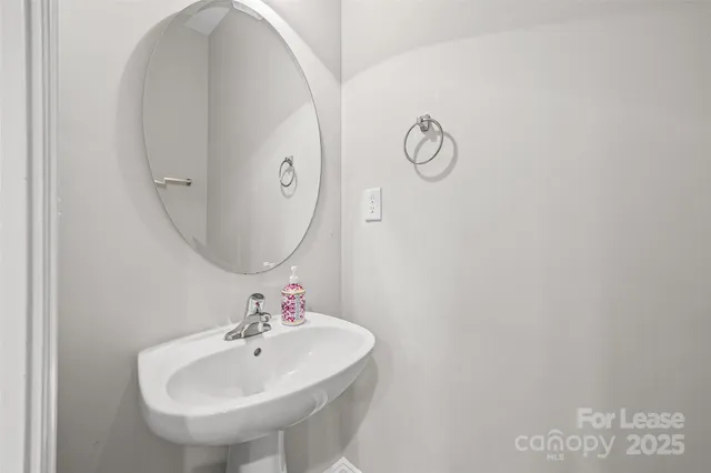 a bathroom with a sink and mirror