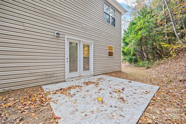 a view of a backyard with large trees