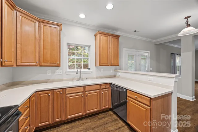 a kitchen with a sink cabinets and window