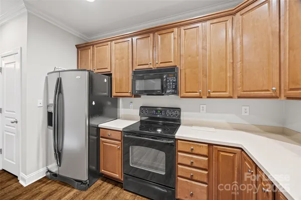 a kitchen with stainless steel appliances granite countertop a refrigerator stove and sink