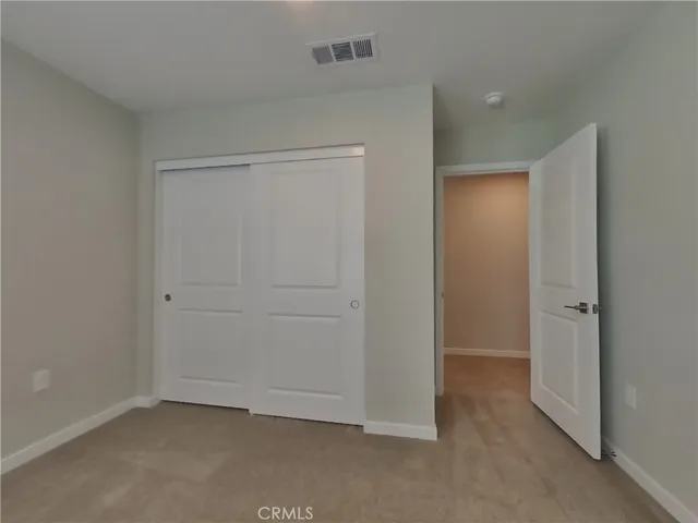an empty room that has a wooden cupboard