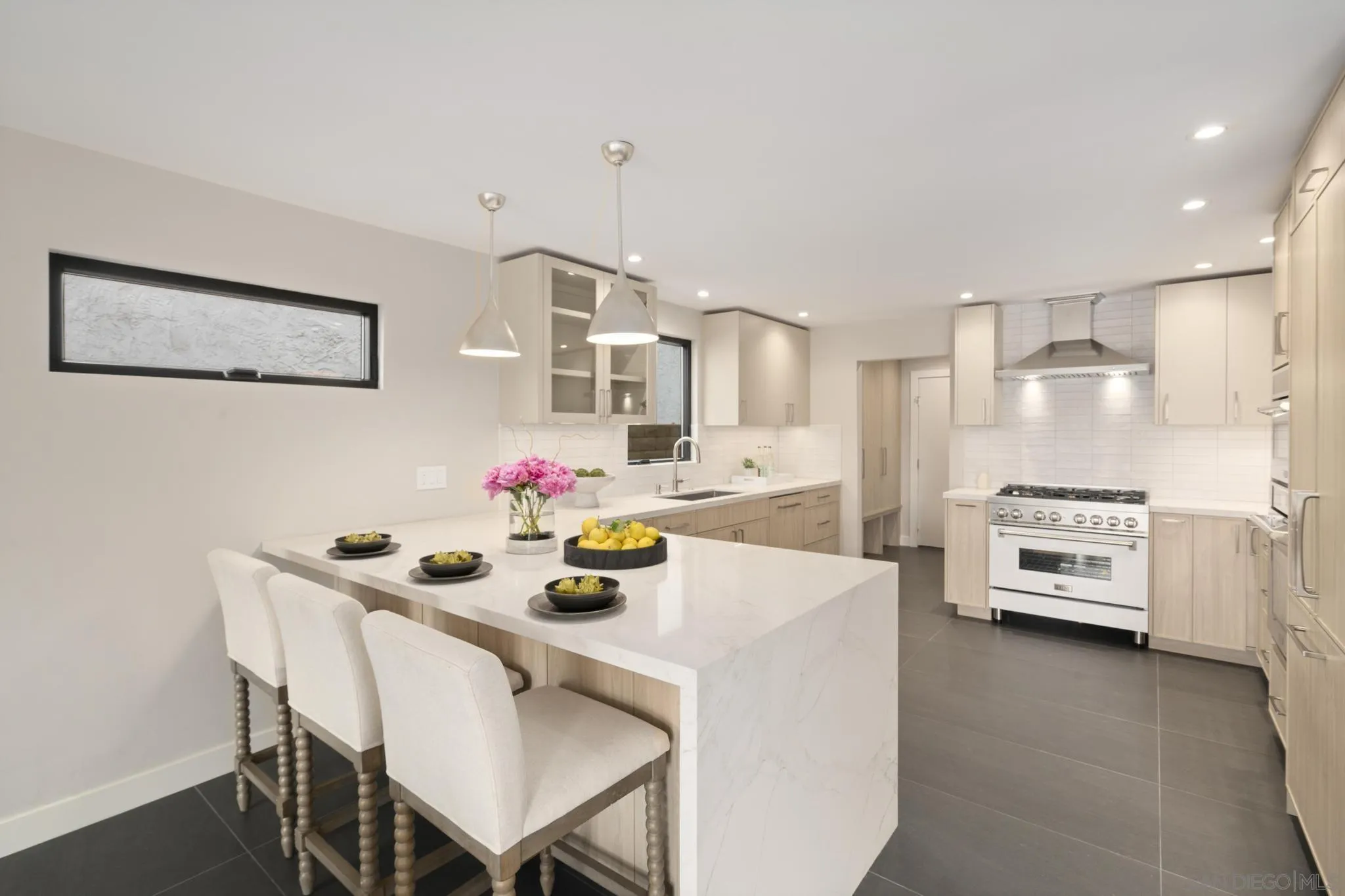 41 Blue Anchor Cay Road Coronado, CA 92118 - Photo 40 of 74 a kitchen with stainless steel appliances a sink a stove a dining table and chairs
