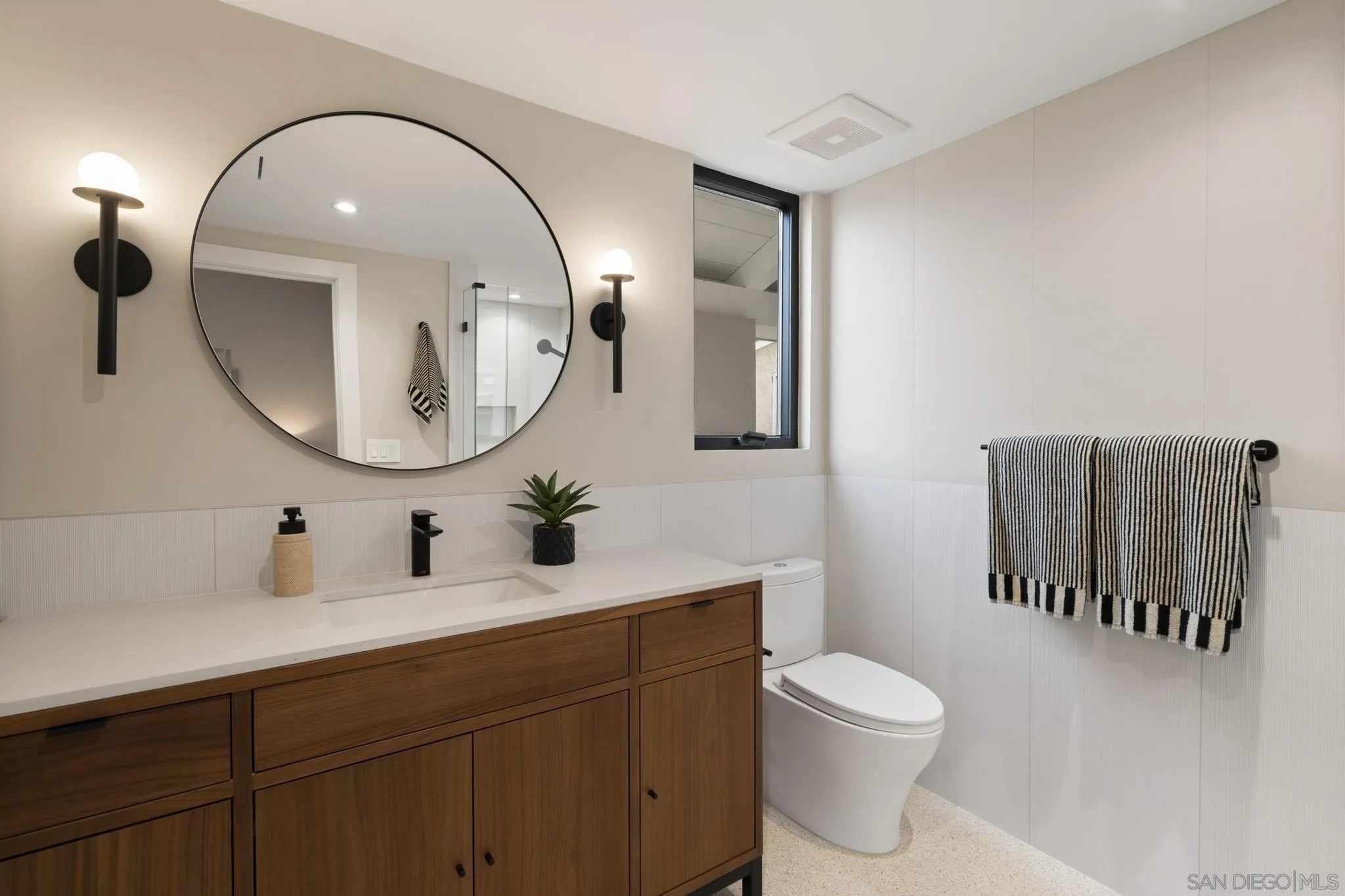41 Blue Anchor Cay Road Coronado, CA 92118 - Photo 63 of 74 a bathroom with a toilet a sink a mirror and a window