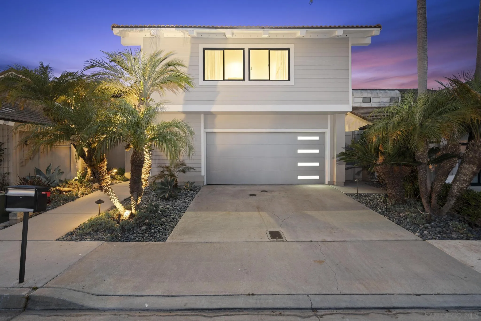 41 Blue Anchor Cay Road Coronado, CA 92118 - Photo 7 of 74 a front view of a house with a yard and garage