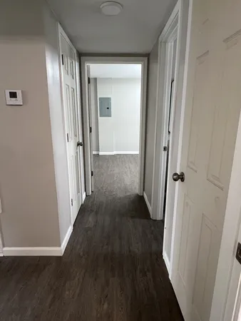 a view of a hallway with wooden floor