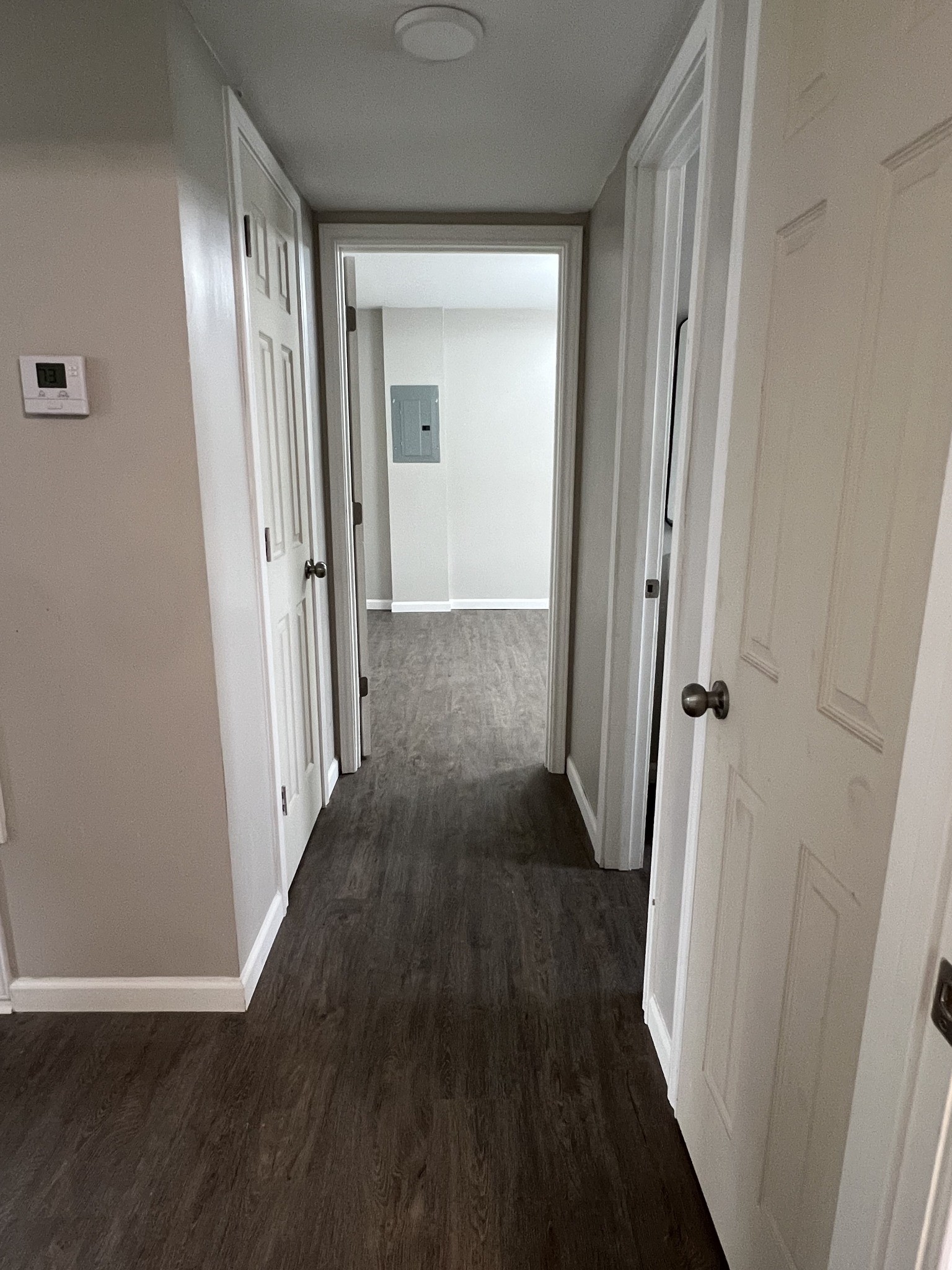 9745 Long Point Road, Unit 37 Houston, TX 77055 - Photo 12 of 17 nterior hallway view with updated flooring and access to multiple rooms.