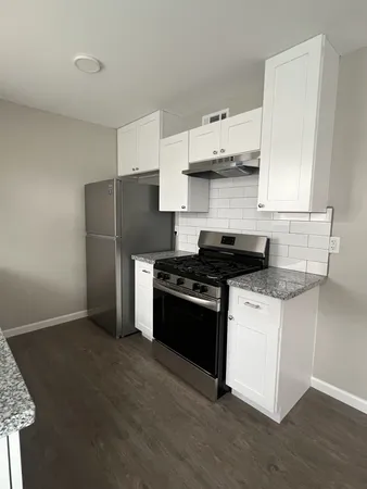 a kitchen with stainless steel appliances granite countertop a stove a refrigerator and a granite counter tops