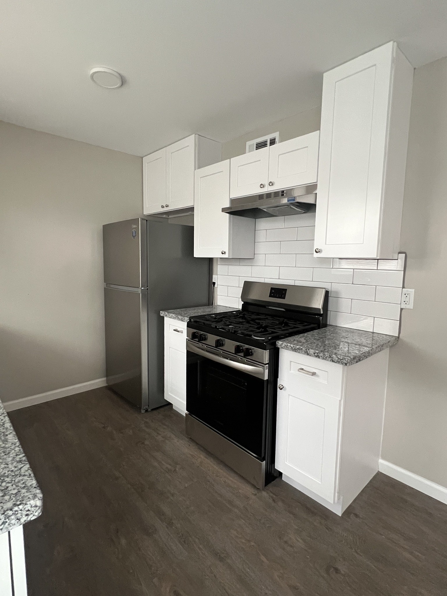 9745 Long Point Road, Unit 37 Houston, TX 77055 - Photo 15 of 17 Kitchen cooking area with stainless appliances, range hood, and surrounding countertop space.