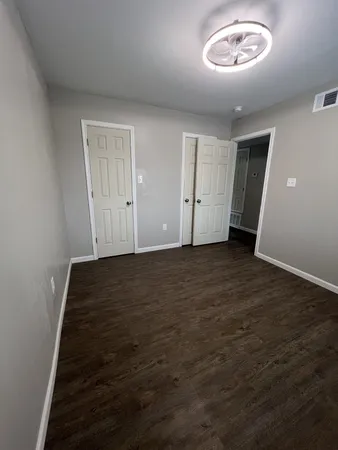 an empty room with a empty space and windows