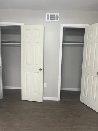 a view of an empty room with closet area