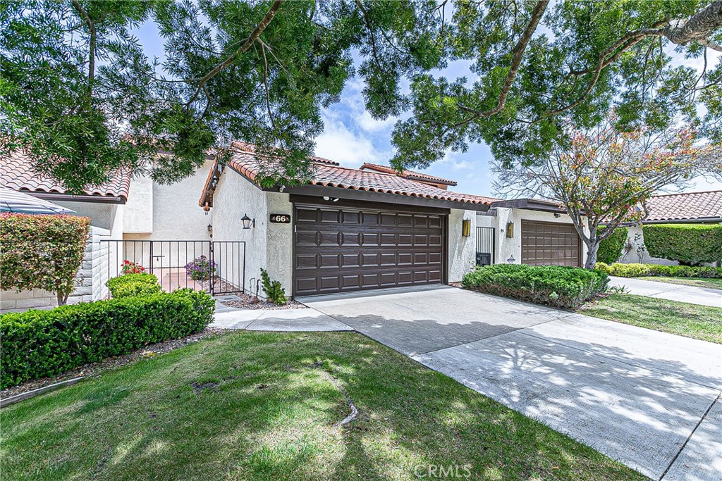 66 Stanford Circle Lompoc, CA 93436 - Photo 1 of 29 a front view of a house with a garden and yard