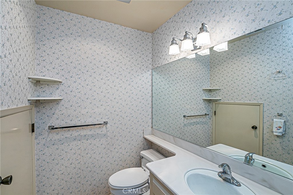66 Stanford Circle Lompoc, CA 93436 - Photo 20 of 29 a bathroom with a sink a toilet and a mirror