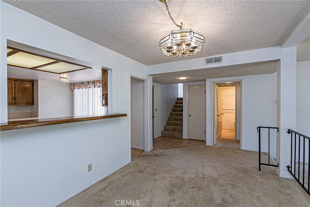 66 Stanford Circle Lompoc, CA 93436 - Photo 6 of 29 a view of a hallway with chandelier and windows