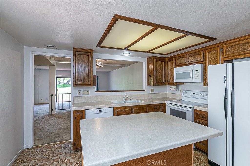 66 Stanford Circle Lompoc, CA 93436 - Photo 9 of 29 a kitchen with stainless steel appliances granite countertop a refrigerator and a stove top oven