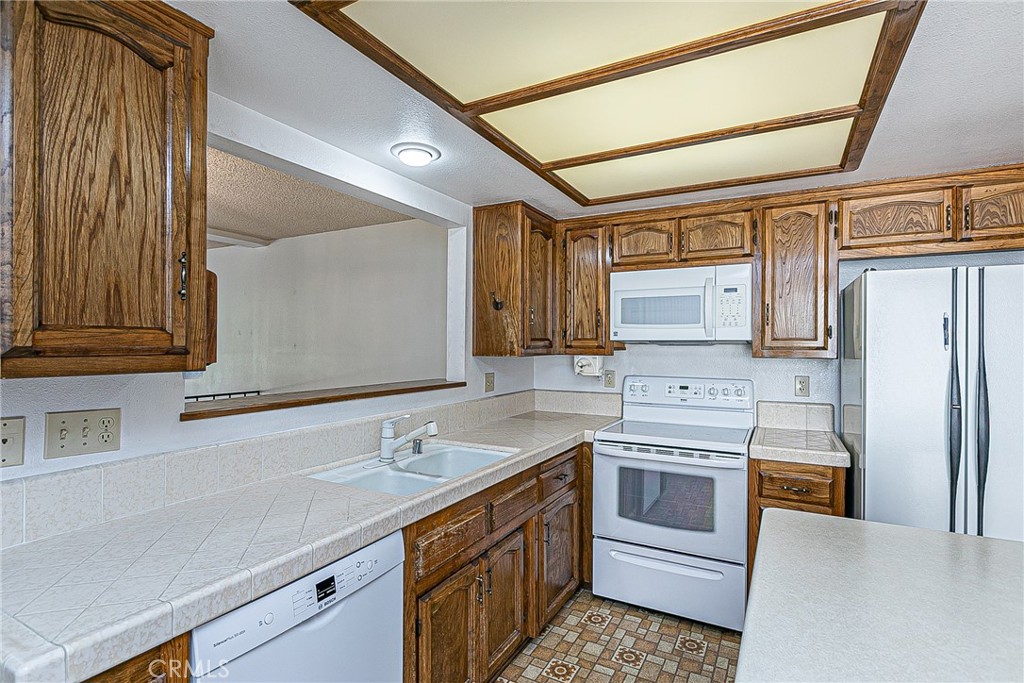 66 Stanford Circle Lompoc, CA 93436 - Photo 10 of 29 a kitchen with a sink cabinets stainless steel appliances and a counter top space