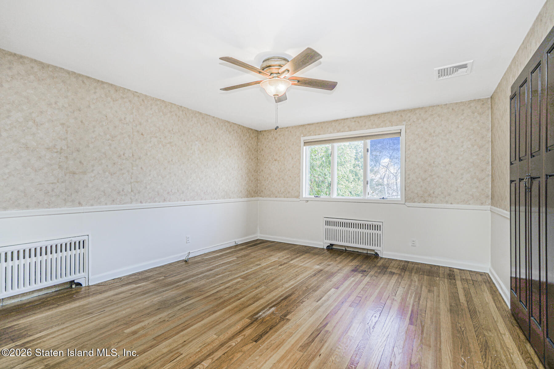 35 Rice Avenue Staten Island, NY 10301 - Photo 14 of 33 wooden floor in an empty room with a window